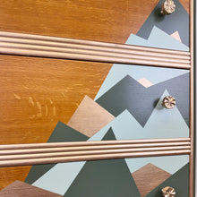 Load image into Gallery viewer, upcycled mid century chest of drawers mountain design in green and gold