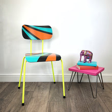 Load image into Gallery viewer, chair with neon yellow legs painted with an orange, blue and black geometric design
