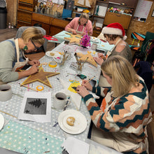 Load image into Gallery viewer, UPcycling workshop session with people painting wooden stars