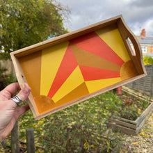 Load image into Gallery viewer, Wooden tray with geometric red and yellow design held outdoors