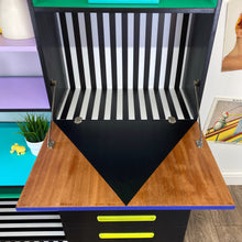 Load image into Gallery viewer, Bright yellow, blue, green, pink and lilac painted mid century storage unit with black and white striped detail