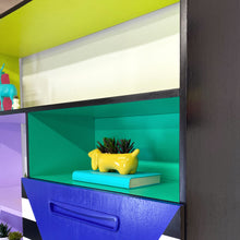 Load image into Gallery viewer, Bright yellow, blue, green, pink and lilac painted mid century storage unit with black and white striped detail