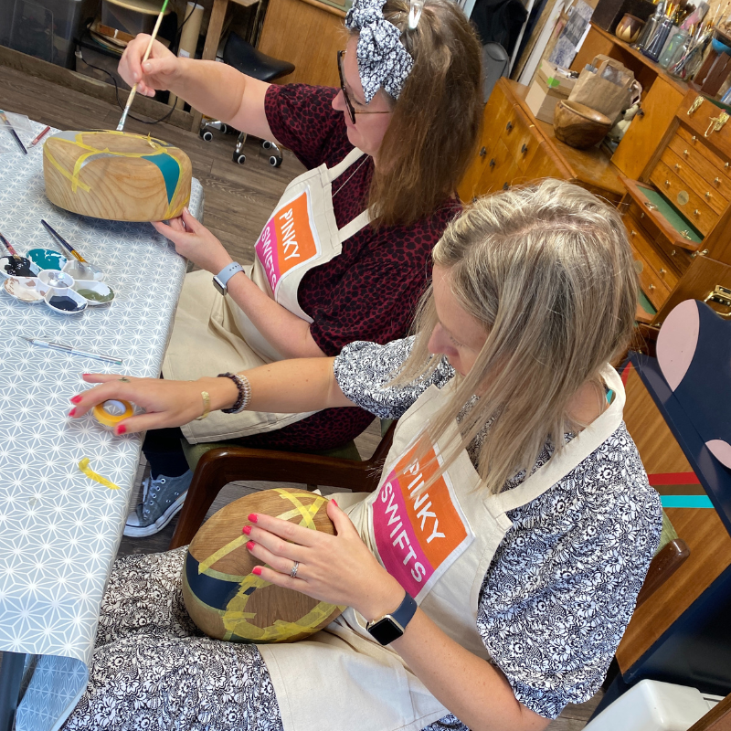 Four woman attending a bowl painting workshop