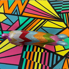 Load image into Gallery viewer, Colorful upcycled glittery wooden pig on a geometric-patterned surface
