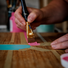 Load image into Gallery viewer, Close up of Amy from Pinkyswifts painting a geometric design on a piece of furniture
