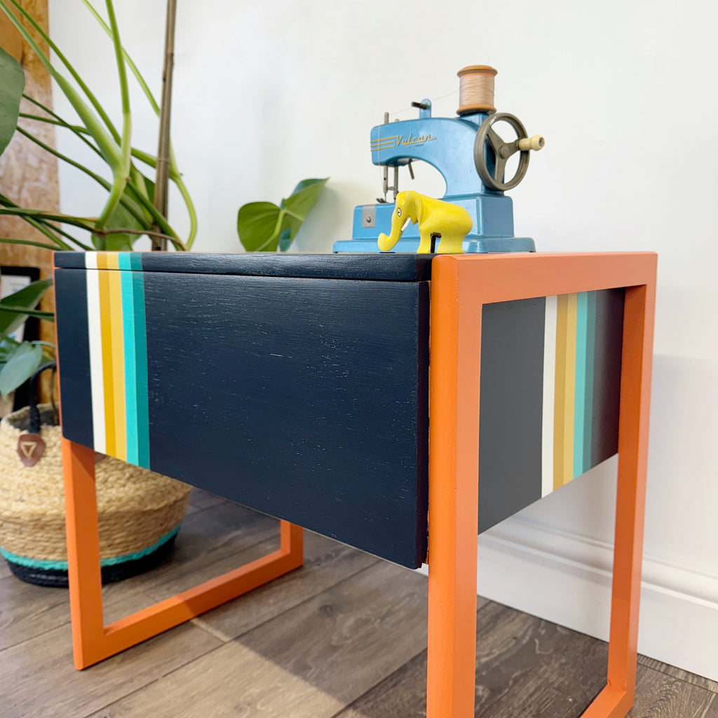 Retro sewing or crafters box painted in orange and blue stripe