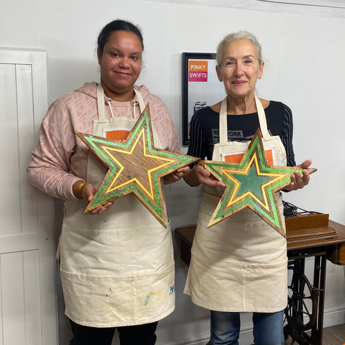 upcycled christmas wooden star handpainted by workshop students
