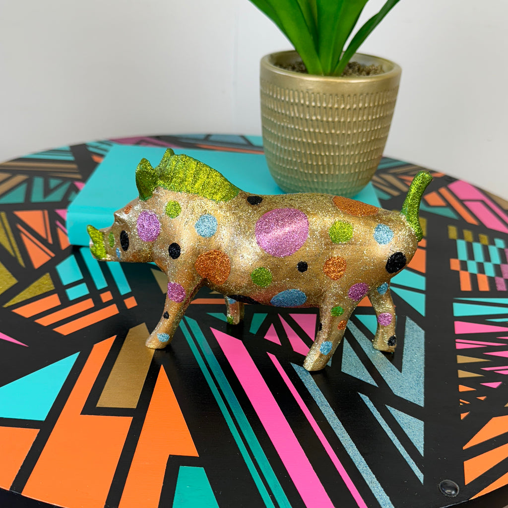 handpainted wooden warthog in gold pink and blue glitter spots upcycled