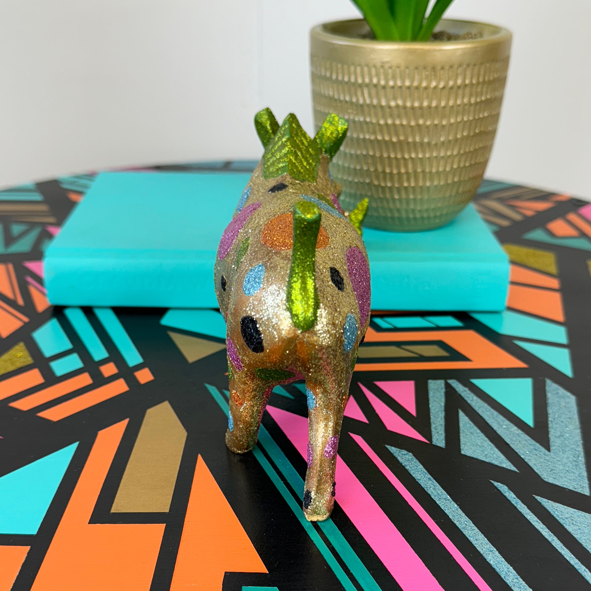 handpainted wooden warthog in gold pink and blue glitter spots upcycled