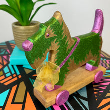Load image into Gallery viewer, handpainted vintage wooden dog on wheels painted in green and gold glitter upcycled
