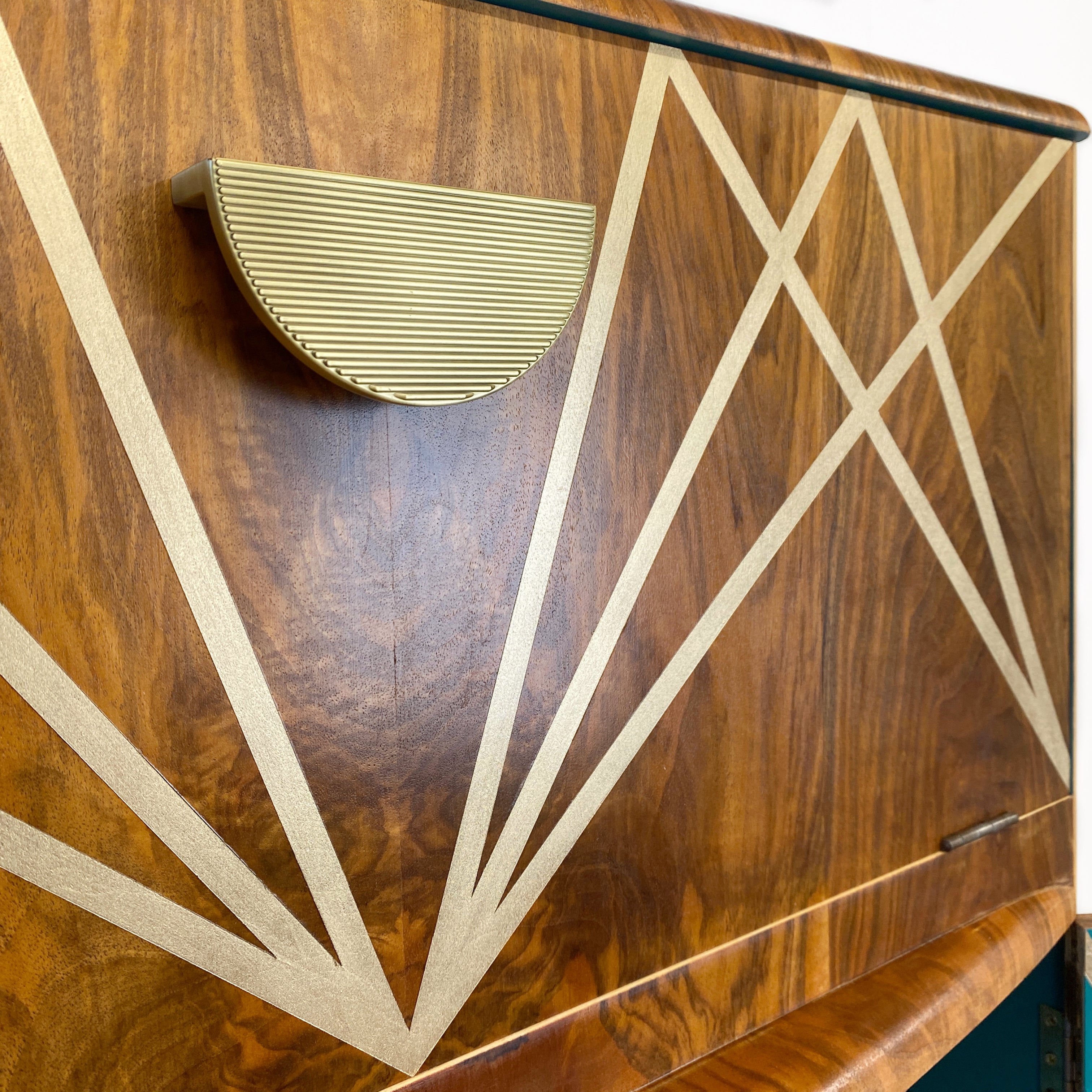 Upcycled drinks cabinet with gold line design