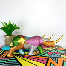 Load image into Gallery viewer, Large wooden rhinoceros handpainted in bright colours, glitter and a gold star design
