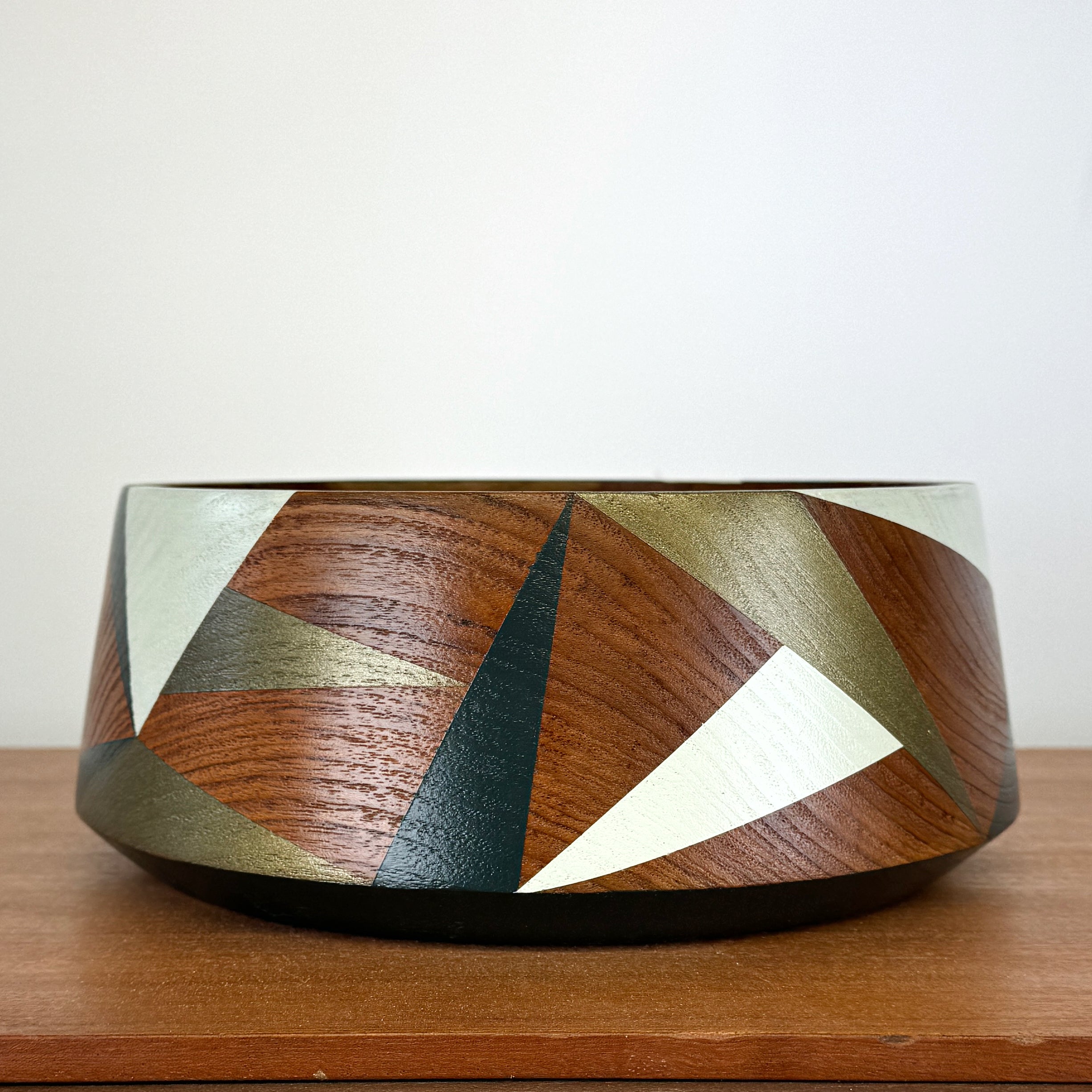 Wooden vintage bowl painted with geometric design in pale green, bronze and dark teal