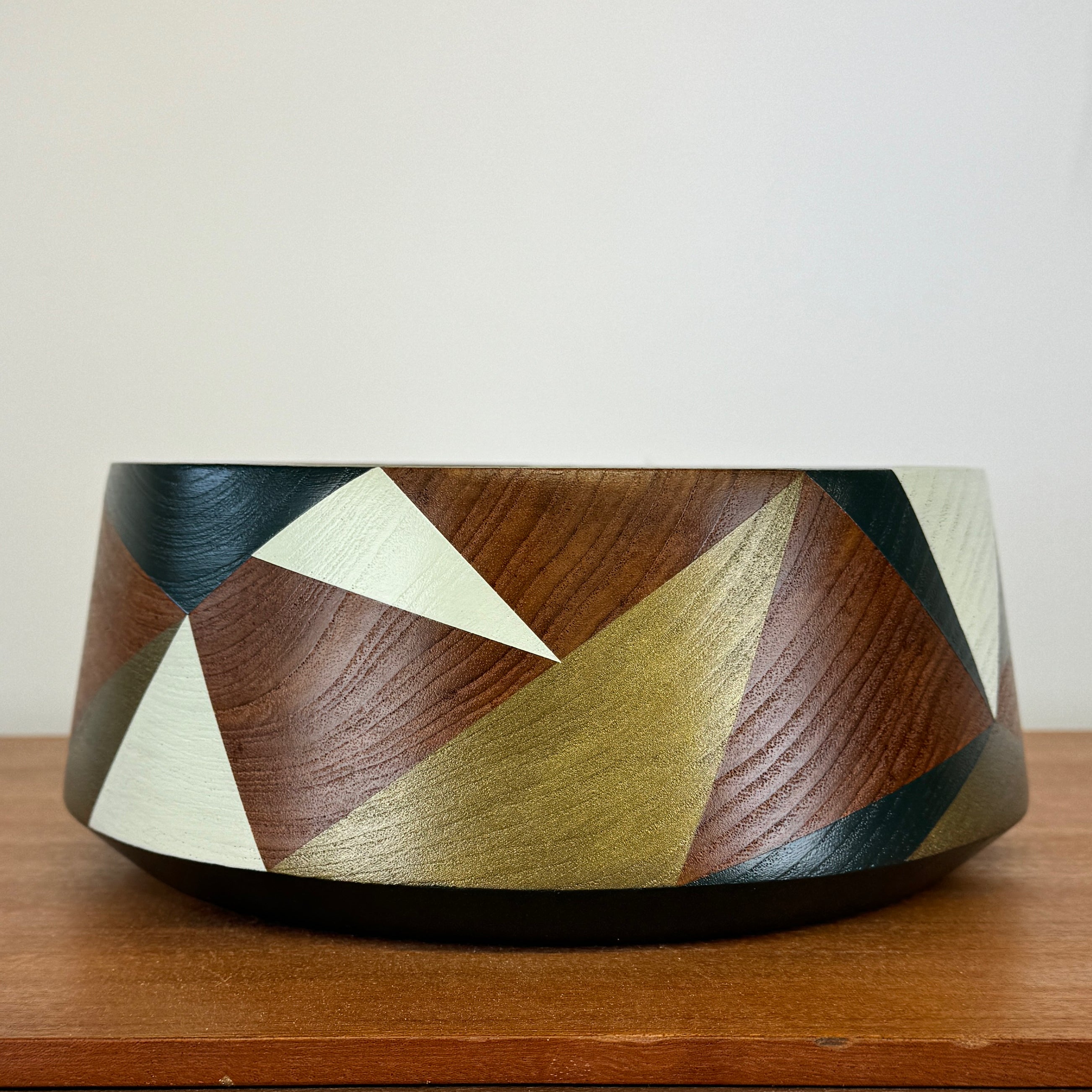 Wooden vintage bowl painted with geometric design in pale green, bronze and dark teal