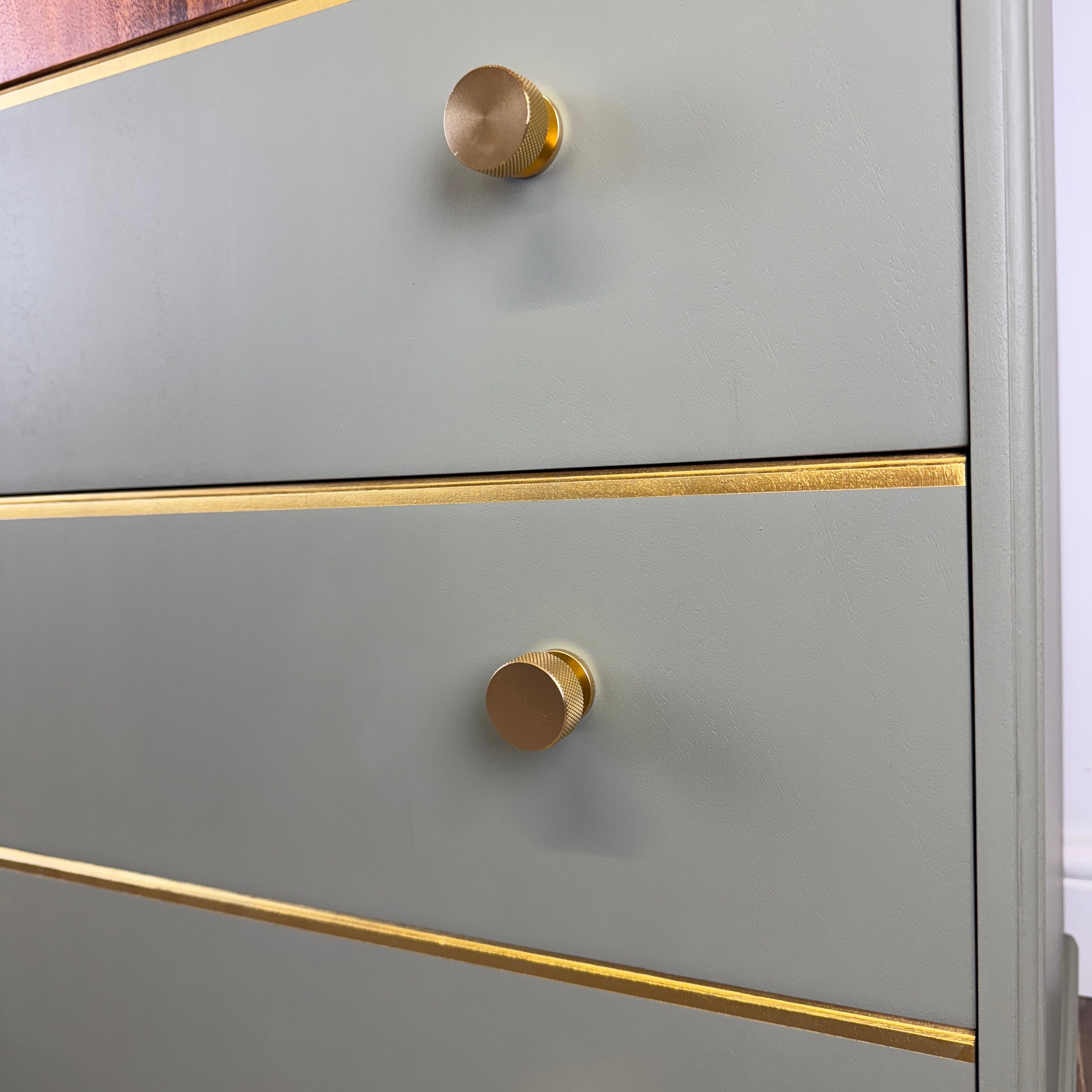 Green chest of drawers  with gold knobs and trim