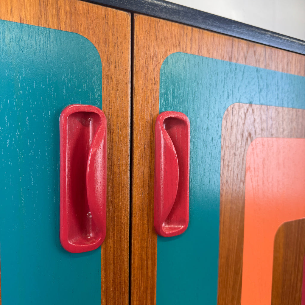 G plan cabinet handles painted in raspberry paint with retro design