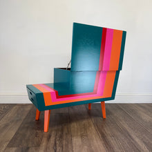 Load image into Gallery viewer, Colorful striped mid century sewing box with a pink elephant figurine on a plain background
