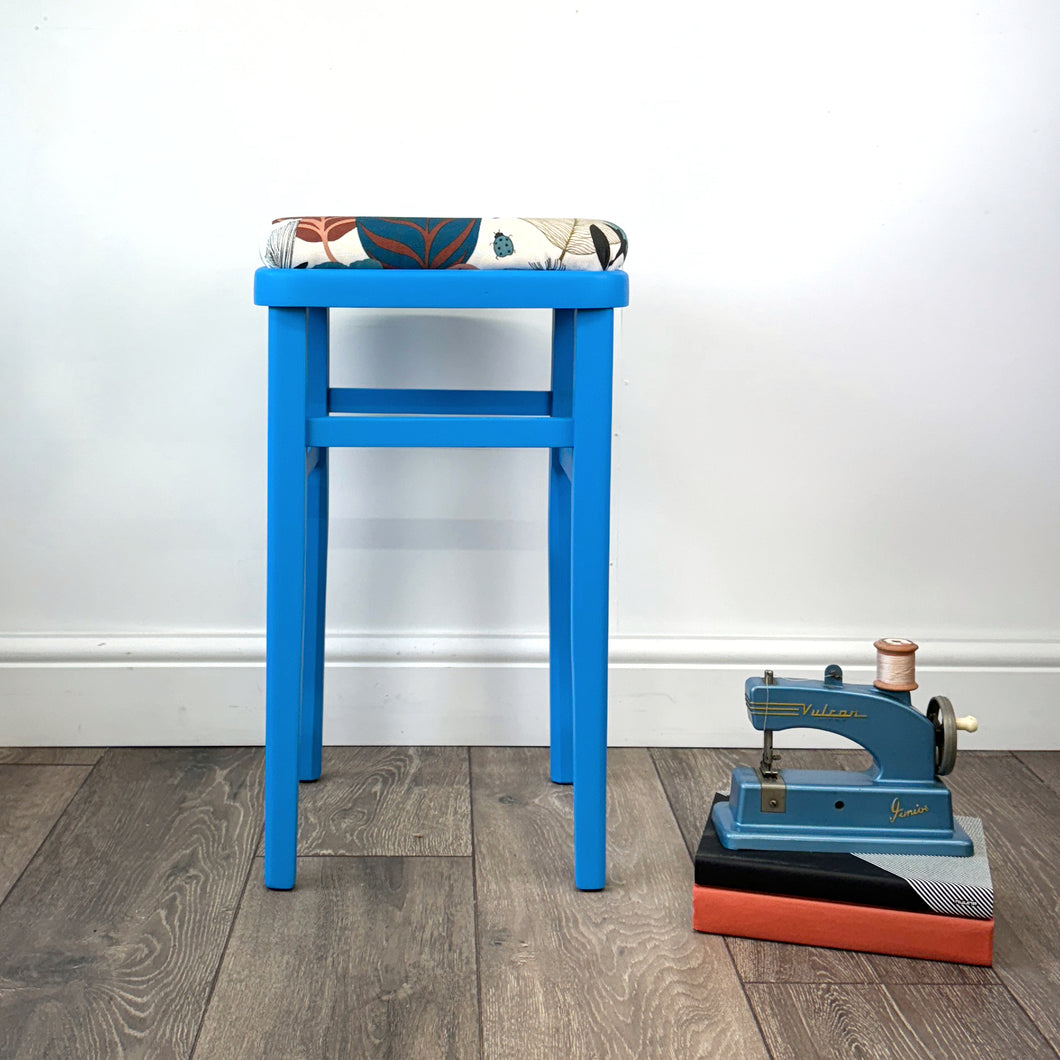 blue painted wooden stool with 1950s inspired flower fabric