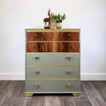Wooden chest of drawers with green base and walnut top