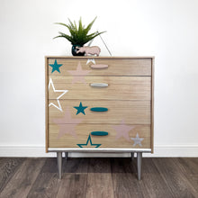 Load image into Gallery viewer, Mid century chest of drawers upcycled with pink teal and silver stars
