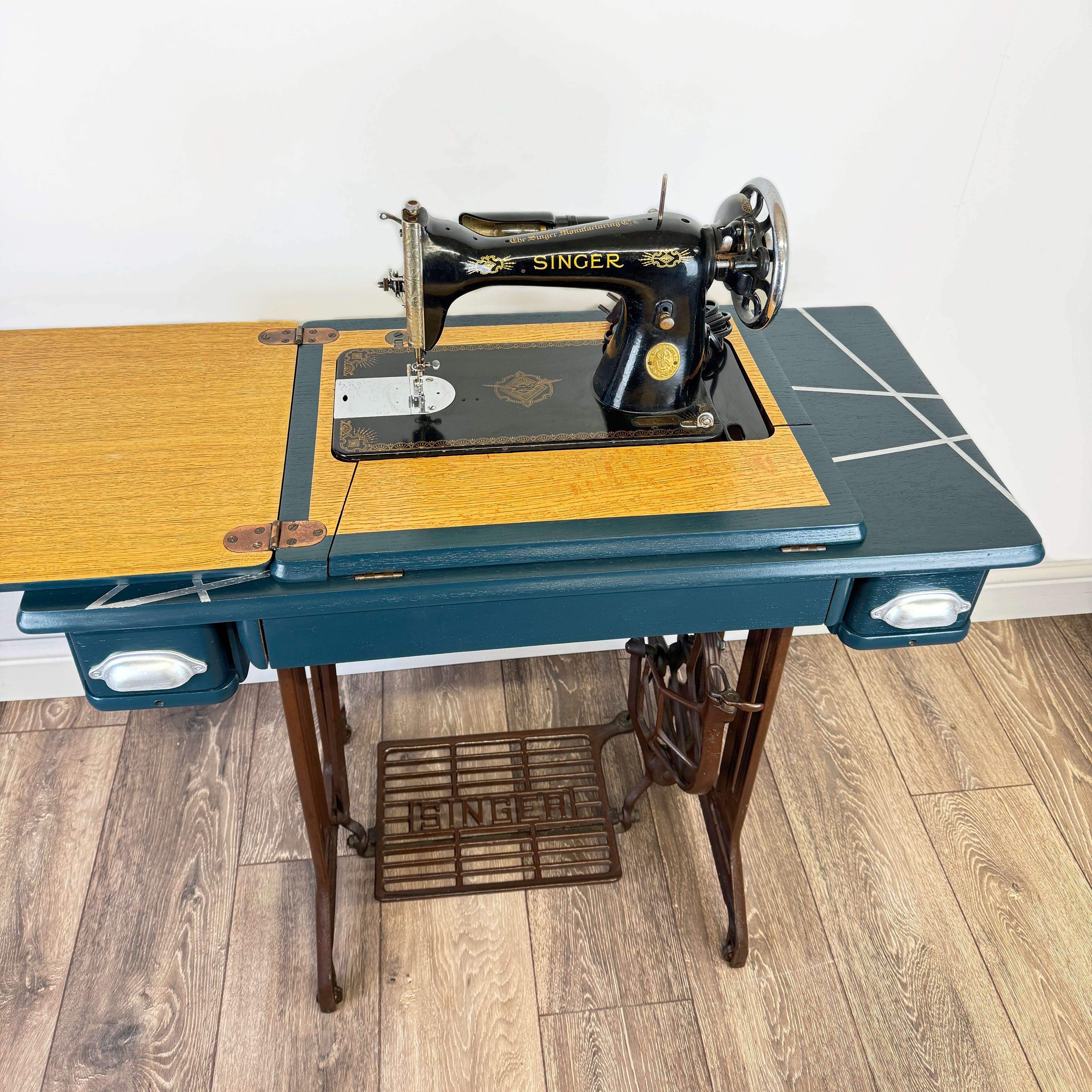 singer sewing machine table painted in blue with silver line design