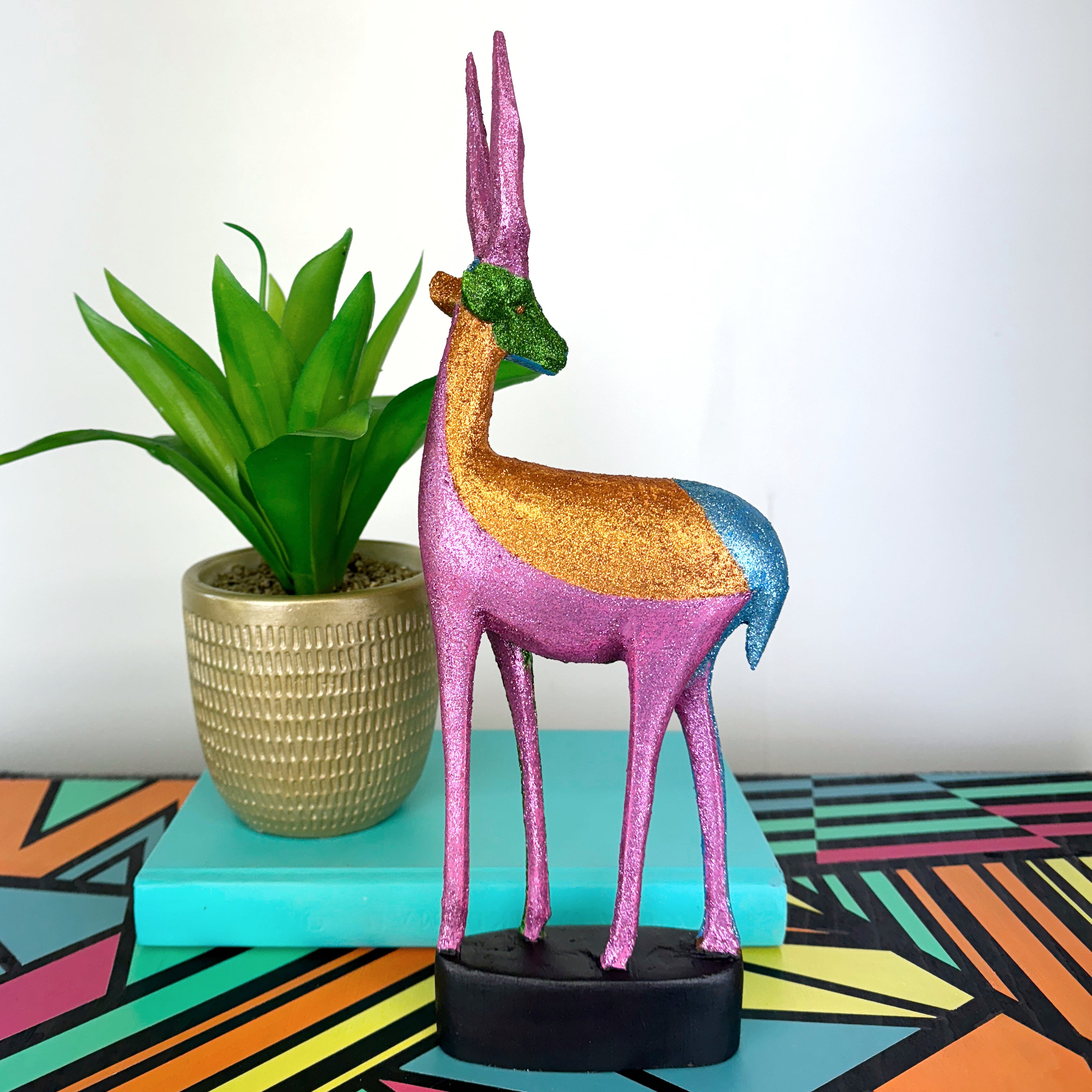 blue green and pink glitter painted wooden stag figurine