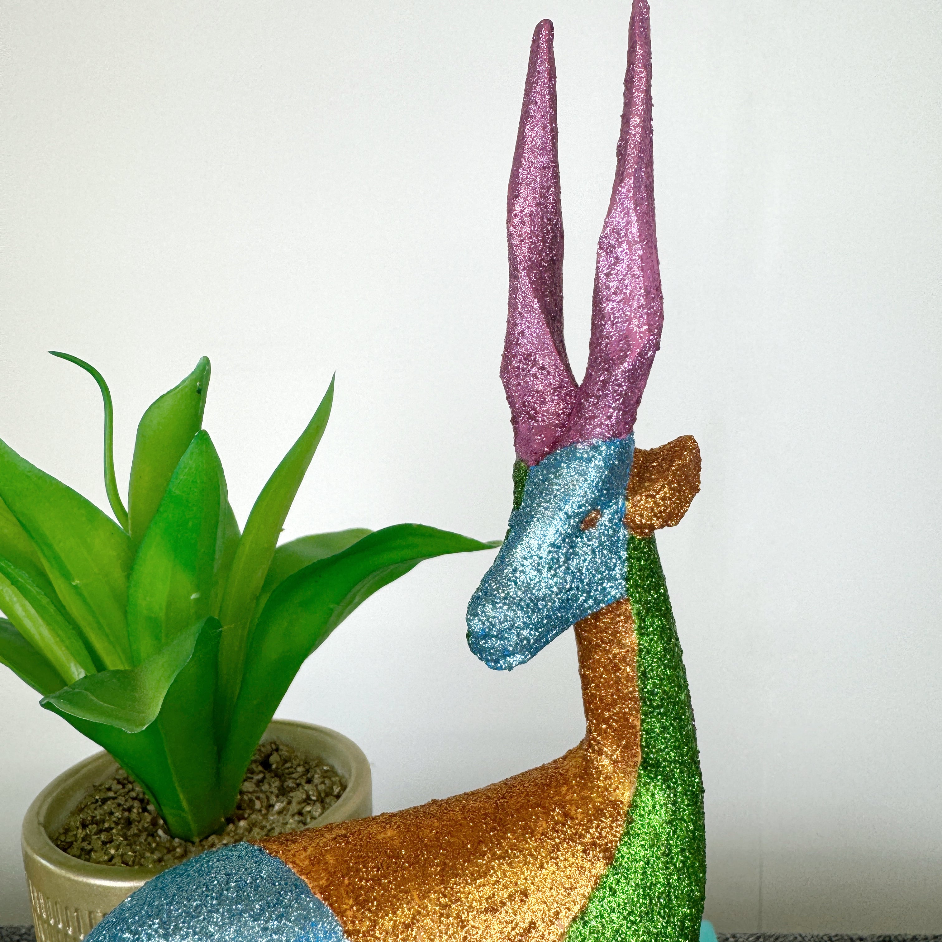 blue green and pink glitter painted wooden stag figurine