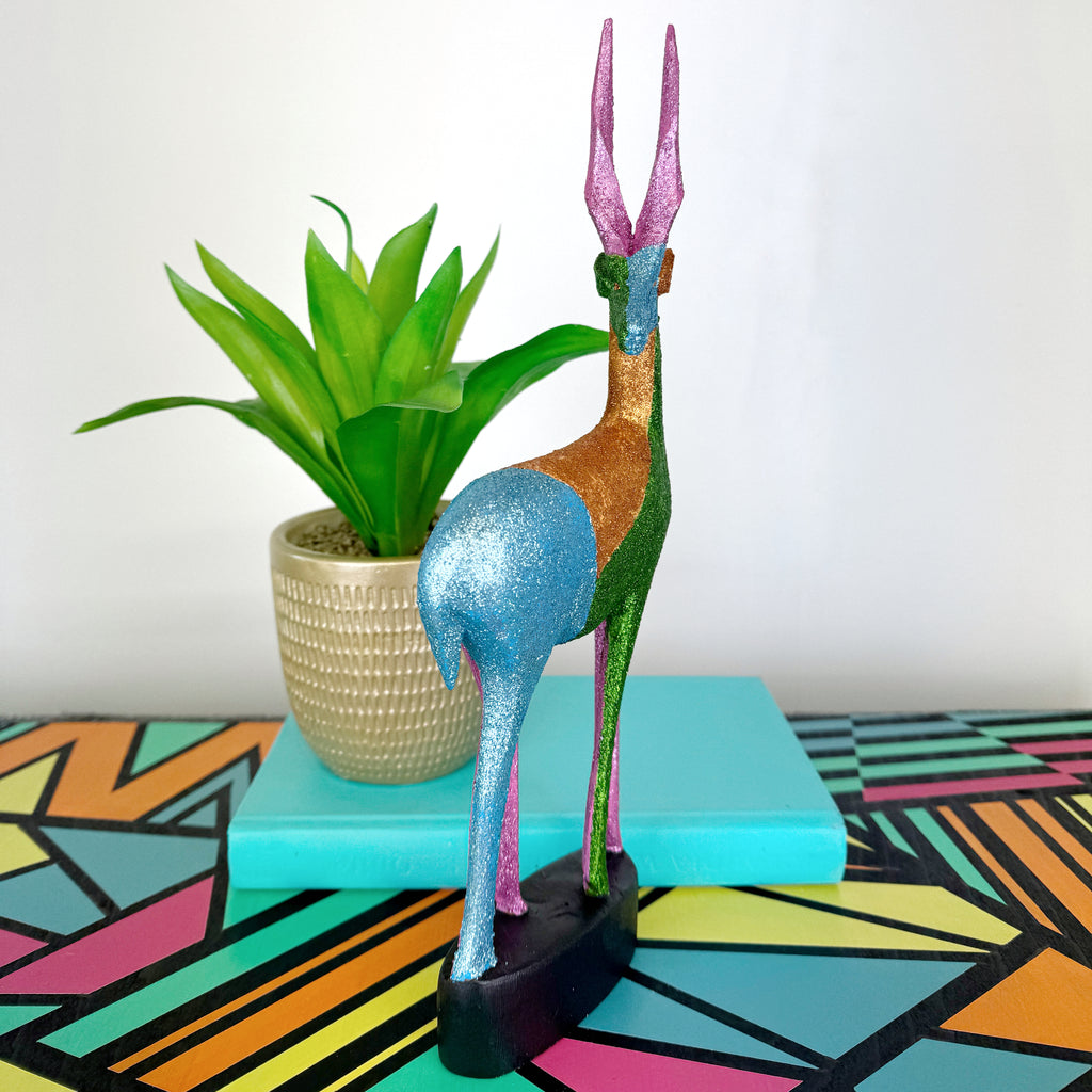 blue green and pink glitter painted wooden stag figurine