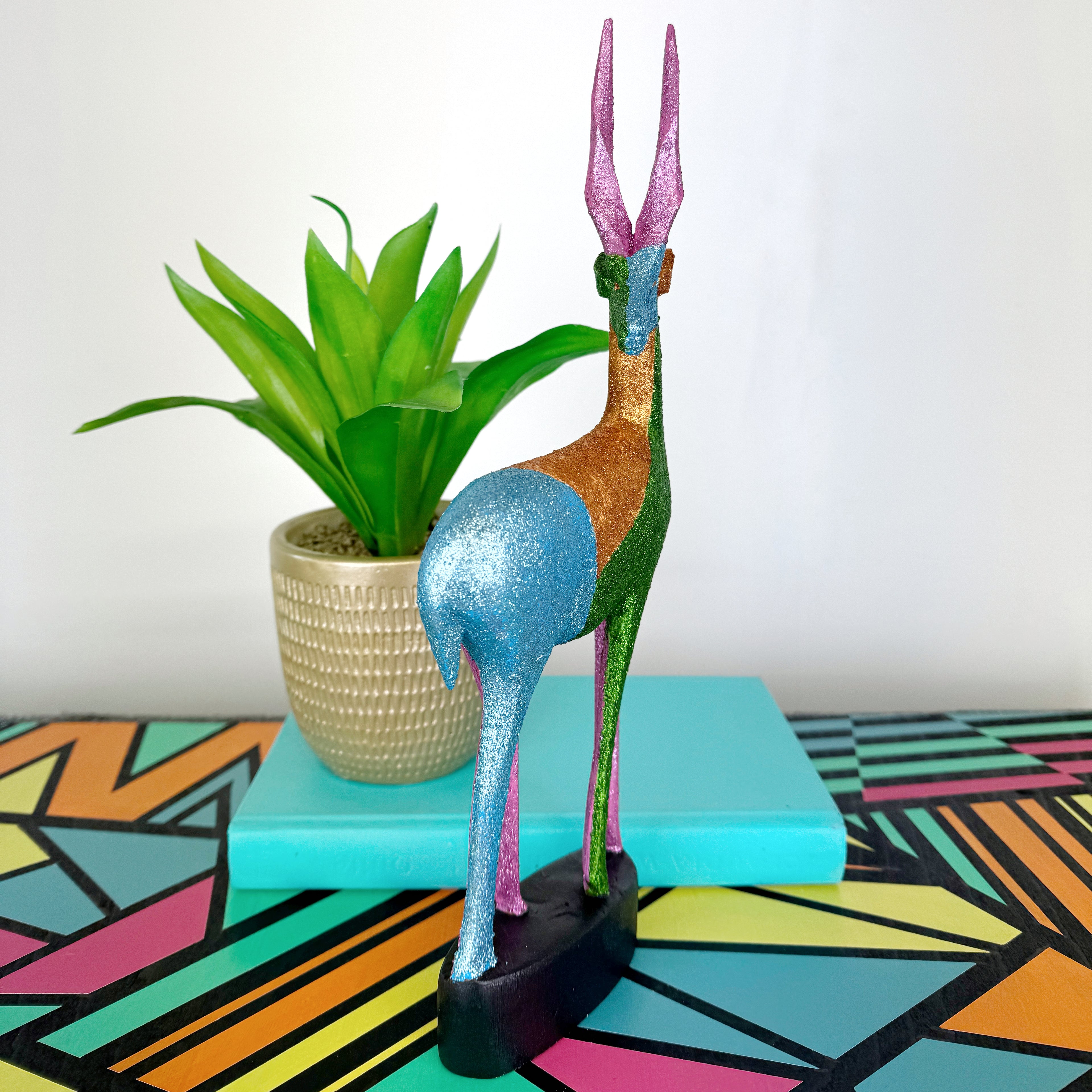 blue green and pink glitter painted wooden stag figurine