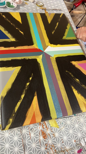 Timelapse video of peeling off tape from Union jack design painted table in right colours and glitter