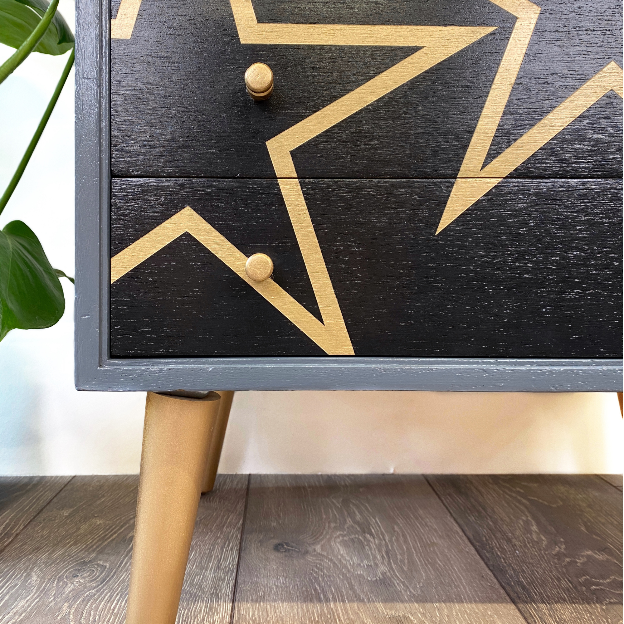 Grey and black upcycled mid century storage unit with handpaingted gold stars