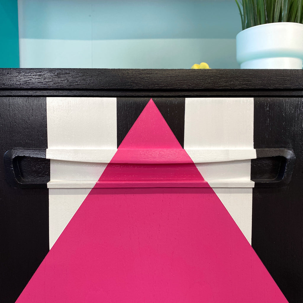 Bright yellow, blue, green, pink and lilac painted mid century storage unit with black and white striped detail