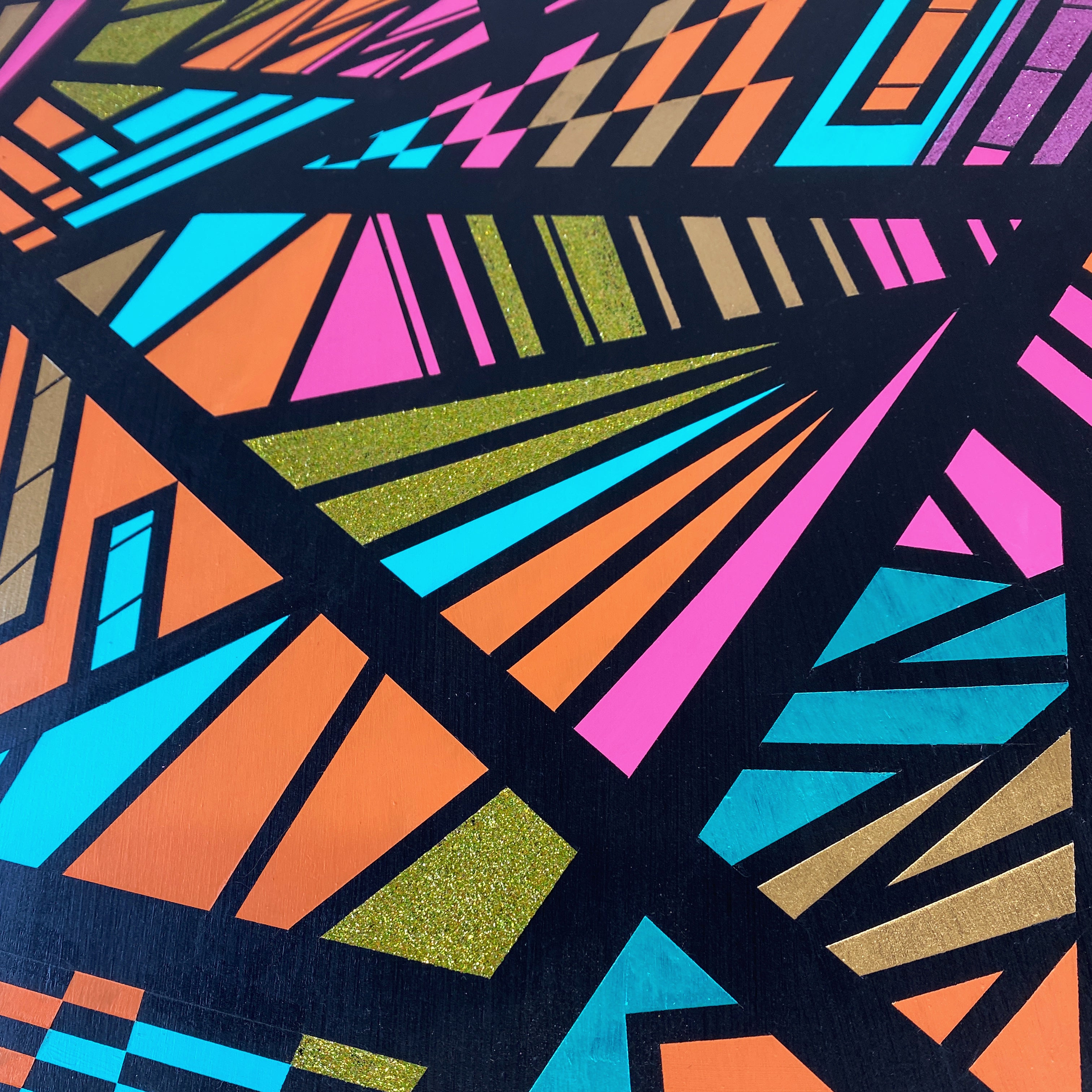 Round coffee table handpainted in bright colours and a geometric design