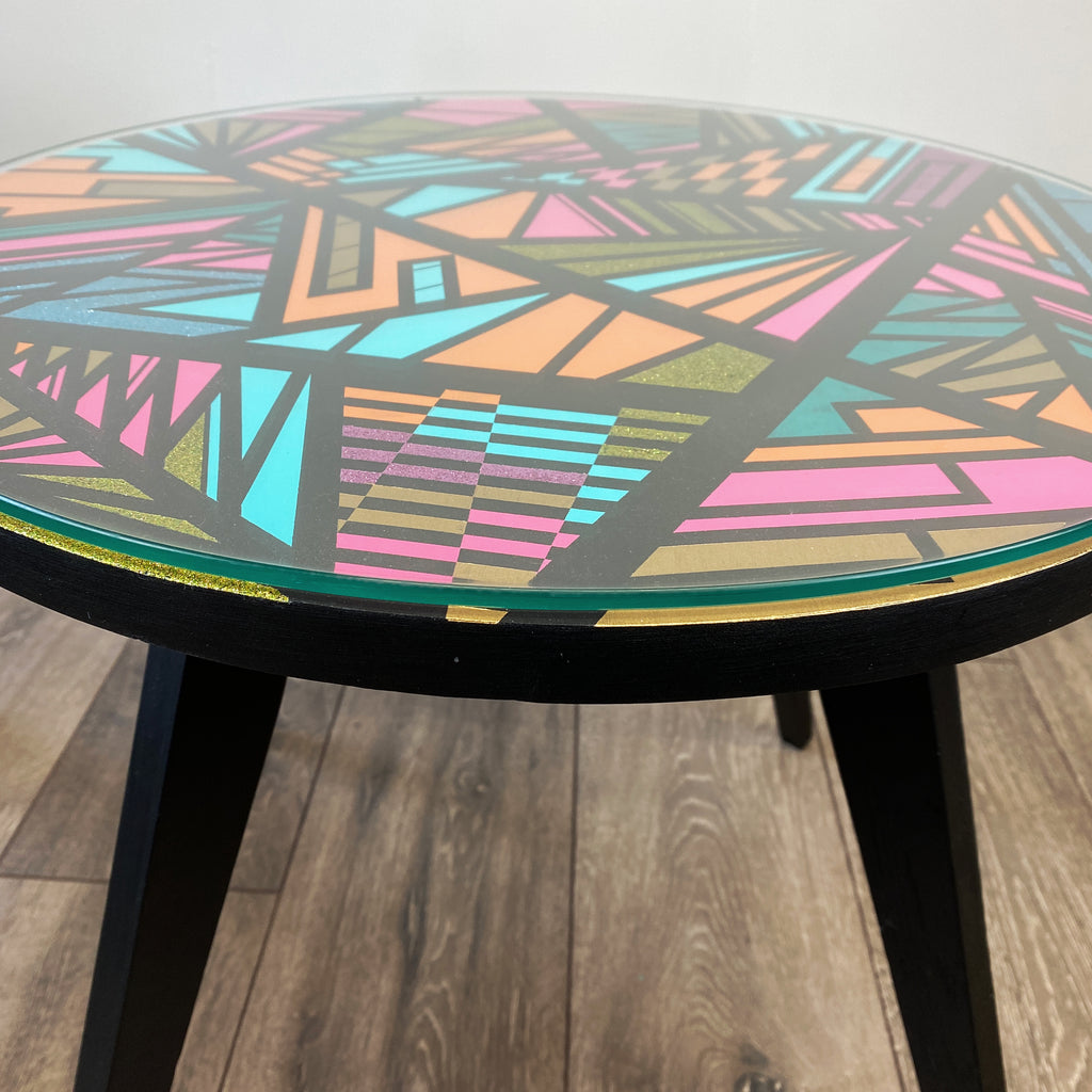 Round coffee table handpainted in bright colours and a geometric design