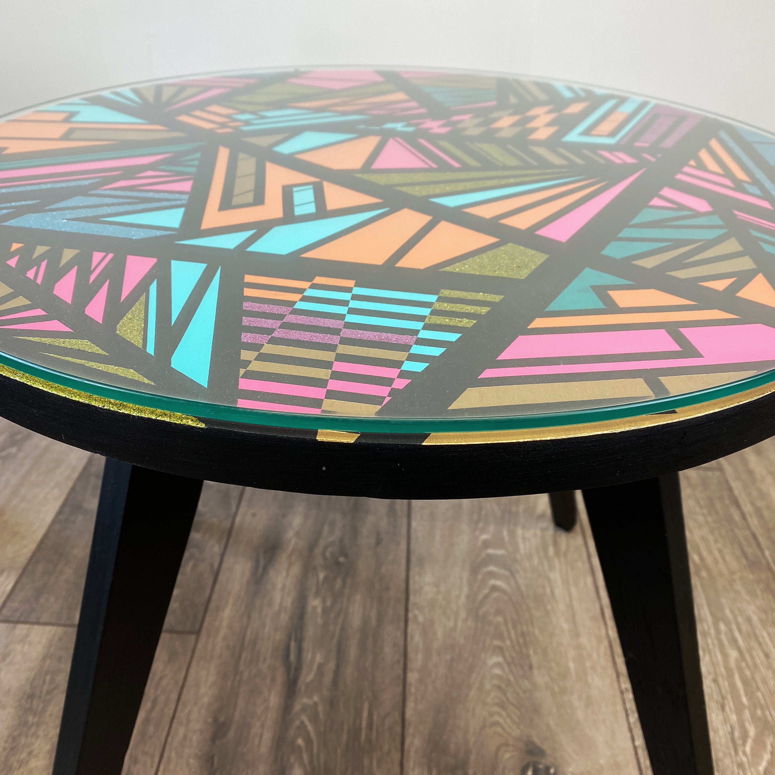 Round coffee table handpainted in bright colours and a geometric design