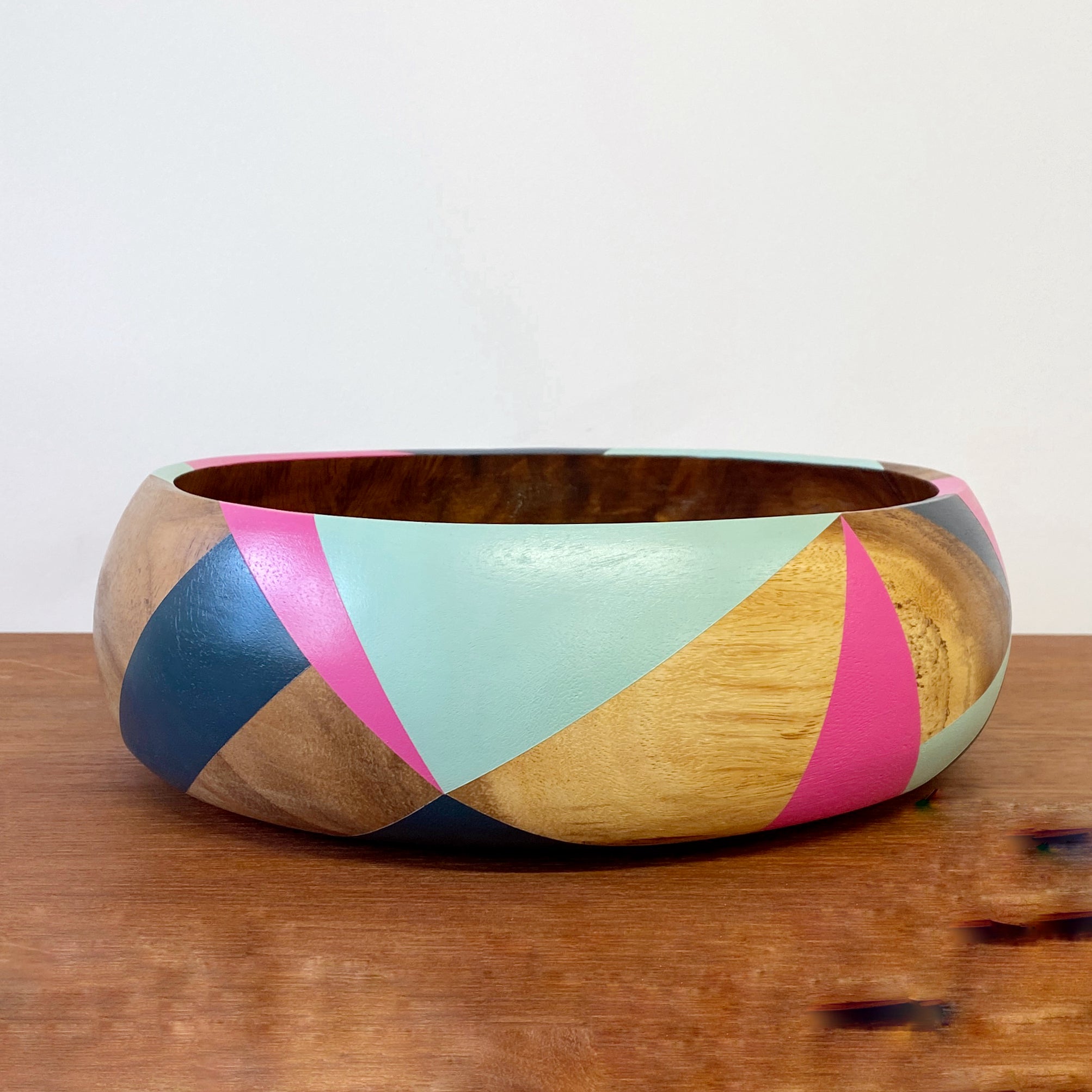 handpainted wooden bowl with triangular geometric design in blue, pink and teal