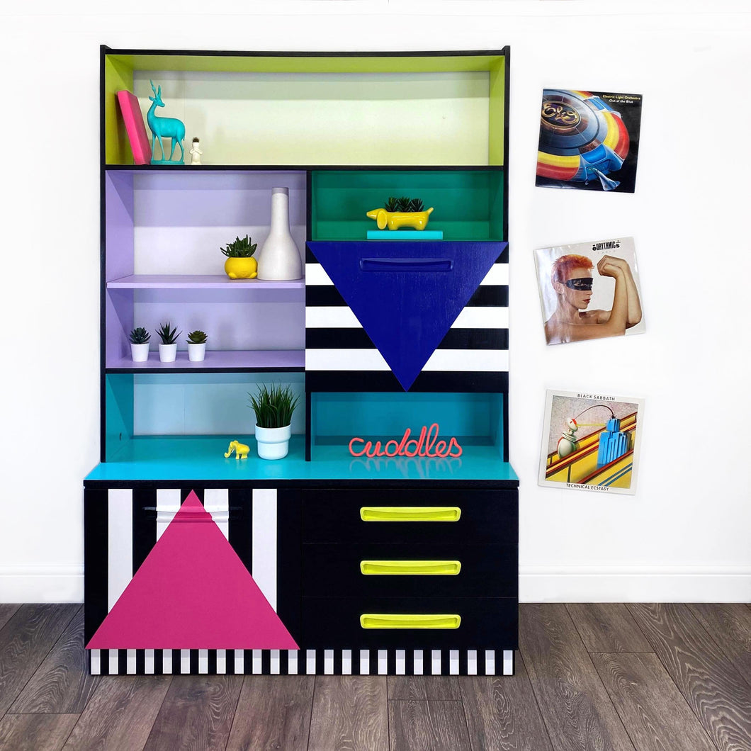 Bright yellow, blue, green, pink and lilac painted mid century storage unit with black and white striped detail