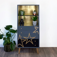 Load image into Gallery viewer, Grey and black upcycled mid century storage unit with handpaingted gold stars
